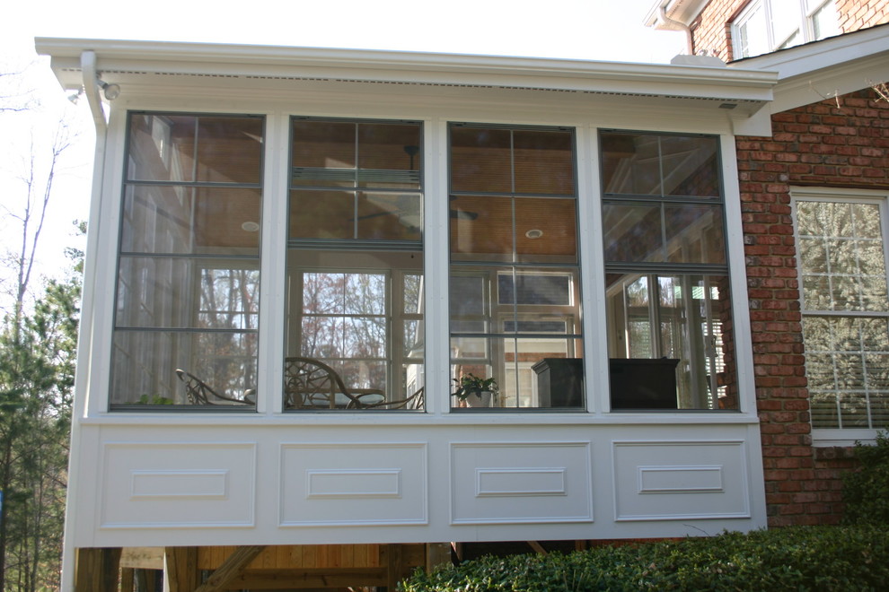 Inspiration for a traditional backyard verandah in Raleigh with a roof extension.
