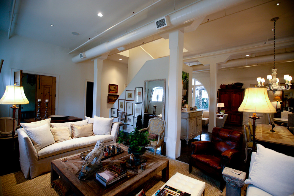 This is an example of a large eclectic formal loft-style living room in Miami with white walls, dark hardwood floors, no fireplace, no tv and brown floor.