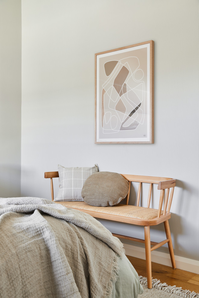Photo of a mid-sized midcentury guest bedroom in Melbourne with green walls, light hardwood floors and wallpaper.