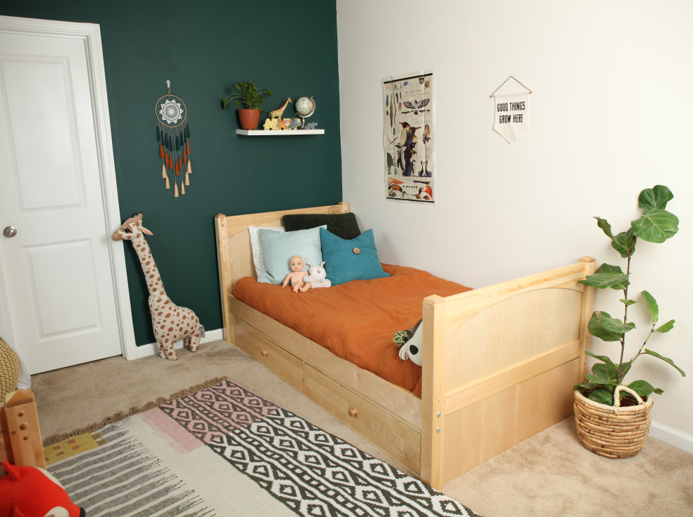 Small traditional gender-neutral kids' room in Other with green walls.