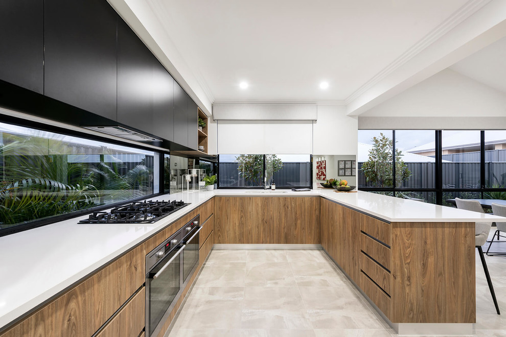Photo of a large contemporary u-shaped open plan kitchen in Perth with an undermount sink, flat-panel cabinets, black cabinets, quartz benchtops, glass sheet splashback, stainless steel appliances, porcelain floors, a peninsula and beige floor.