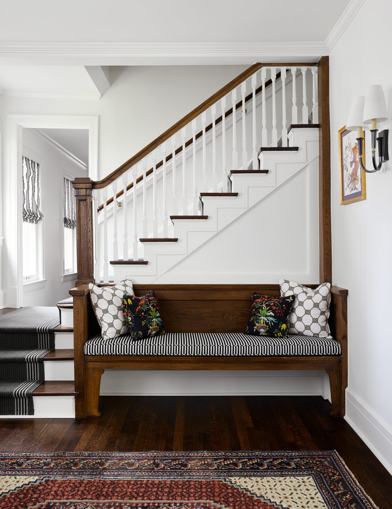 Elegant wooden l-shaped wood railing staircase photo in Chicago with painted risers