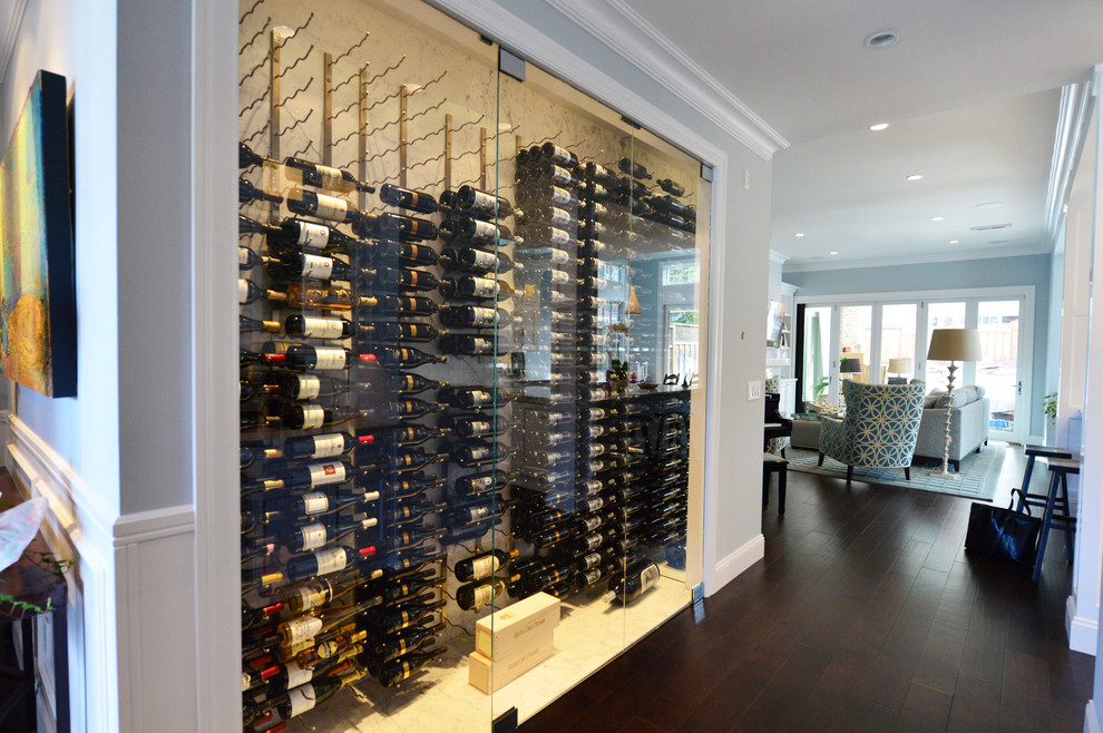 This is an example of an expansive arts and crafts wine cellar in San Francisco with vinyl floors and display racks.