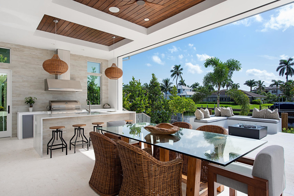 Design ideas for a contemporary patio in Miami with a roof extension.