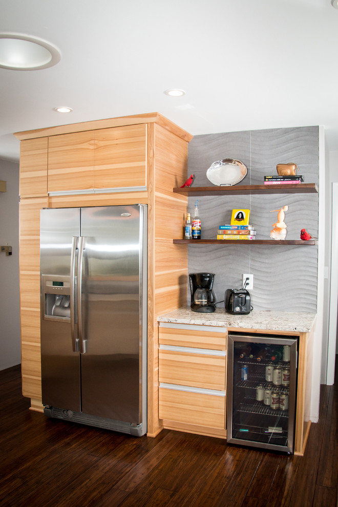 This is an example of a mid-sized modern u-shaped kitchen pantry in Milwaukee with a farmhouse sink, flat-panel cabinets, medium wood cabinets, granite benchtops, grey splashback, porcelain splashback, stainless steel appliances, dark hardwood floors, with island and brown floor.