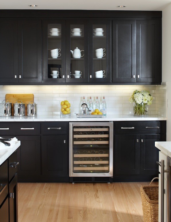 Inspiration for a contemporary u-shaped eat-in kitchen in San Francisco with recessed-panel cabinets, black cabinets, white splashback, subway tile splashback, an undermount sink, marble benchtops and stainless steel appliances.