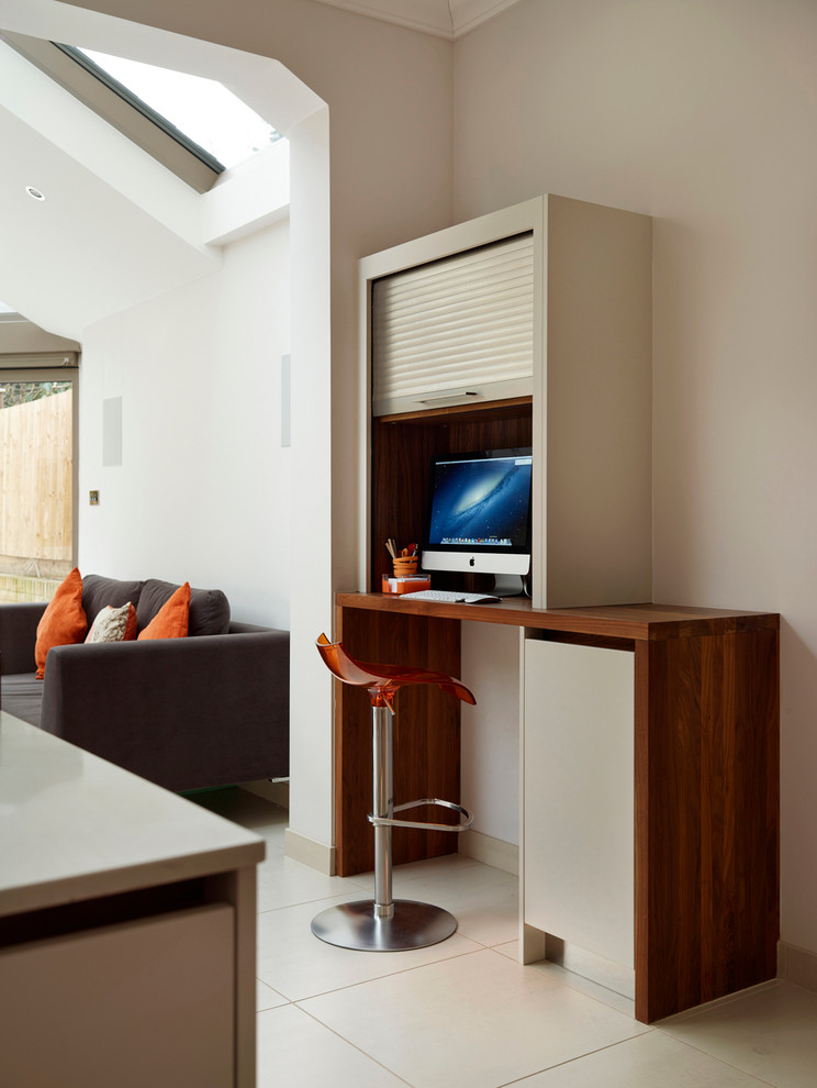 Photo of a small contemporary study room in London with white walls, a built-in desk and no fireplace.