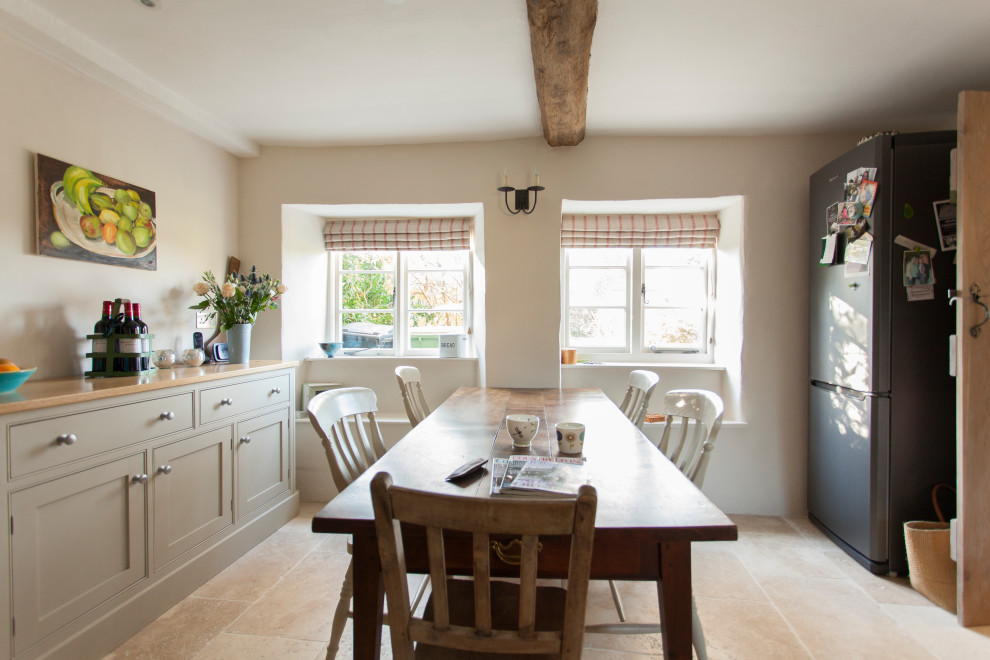 This is an example of a large traditional kitchen/dining combo in Gloucestershire with travertine floors and brown floor.