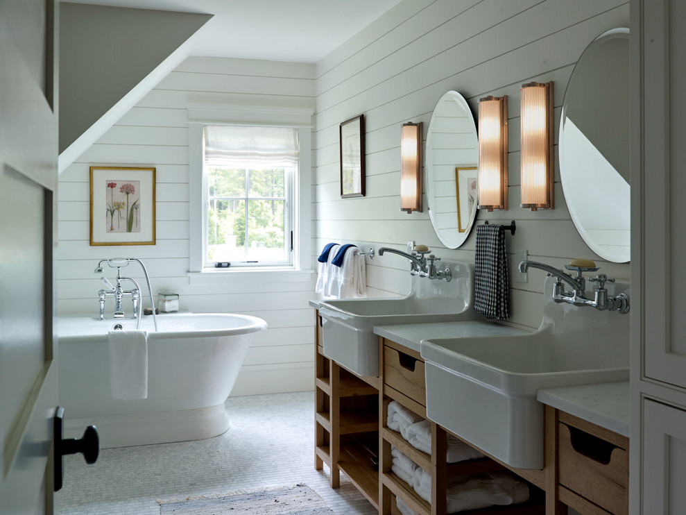 Inspiration for a mid-sized country bathroom in Portland Maine with medium wood cabinets, a freestanding tub, white walls, a trough sink, marble benchtops, white benchtops, mosaic tile floors, white floor, a double vanity and open cabinets.