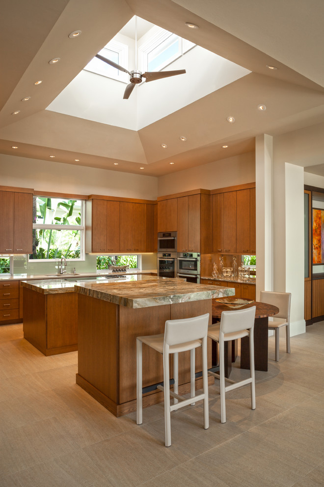 Contemporary kitchen in Miami with flat-panel cabinets, medium wood cabinets, stainless steel appliances and multiple islands.