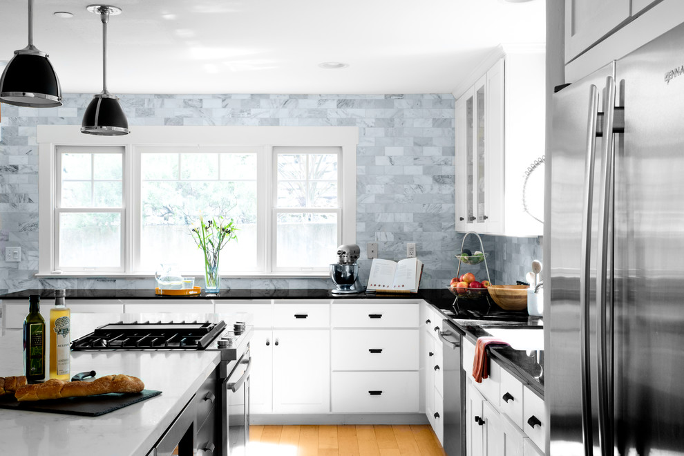 Design ideas for a large contemporary l-shaped open plan kitchen in San Francisco with an undermount sink, shaker cabinets, white cabinets, quartz benchtops, grey splashback, marble splashback, stainless steel appliances, light hardwood floors, with island and beige floor.