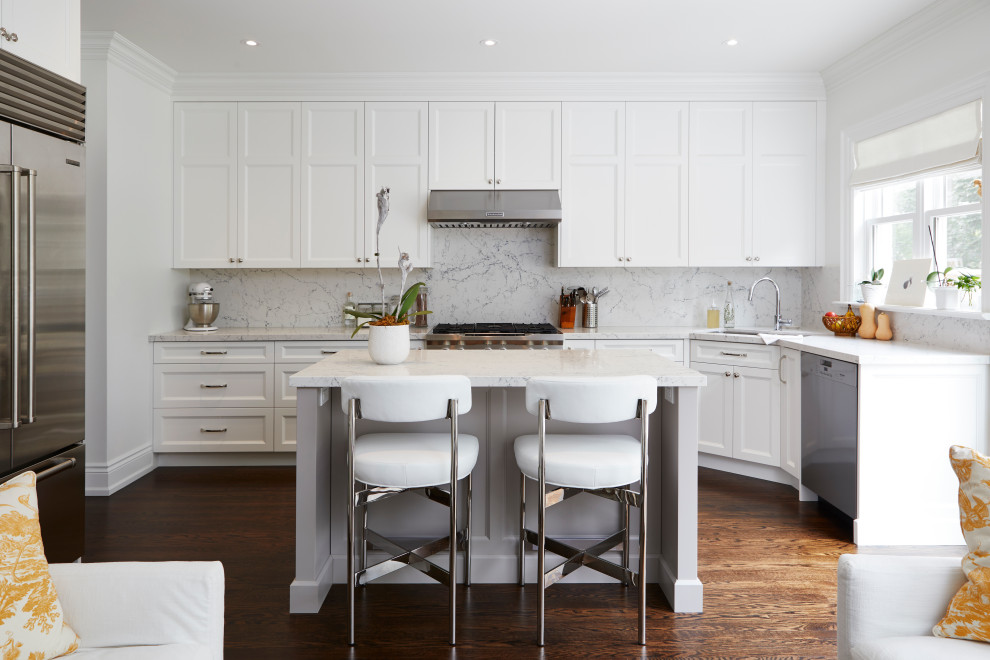 Example of a mid-sized classic l-shaped dark wood floor and brown floor open concept kitchen design in Toronto with an undermount sink, recessed-panel cabinets, white cabinets, quartz countertops, multicolored backsplash, stone slab backsplash, stainless steel appliances, an island and multicolored countertops
