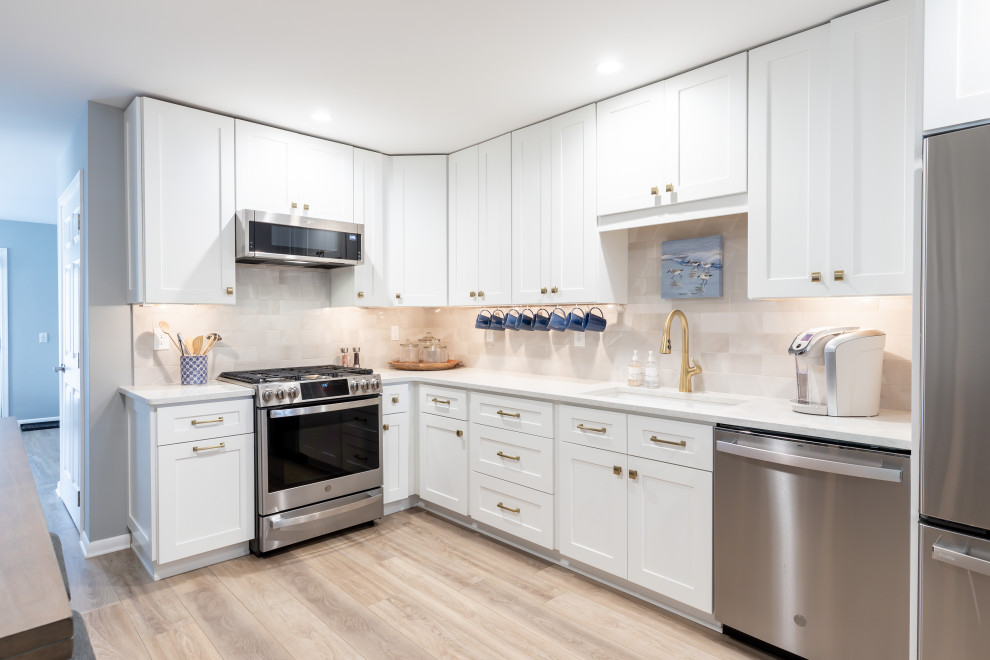 Example of a small transitional l-shaped enclosed kitchen design in Philadelphia with shaker cabinets, white cabinets and no island