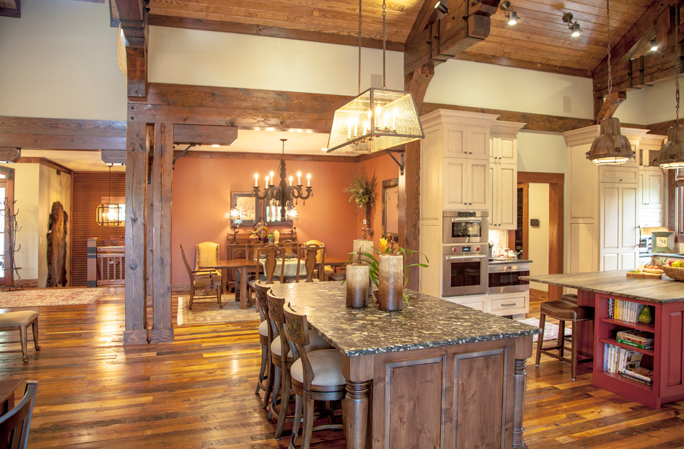 Large country kitchen/dining combo in Other with beige walls, medium hardwood floors and brown floor.