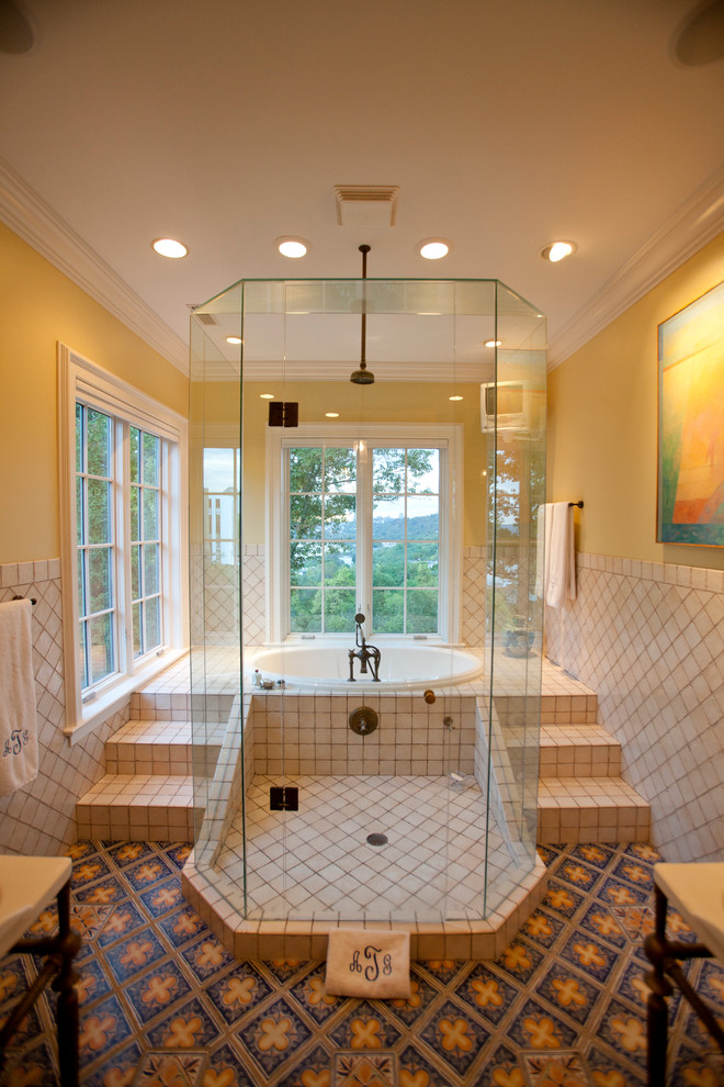Inspiration for a traditional bathroom in Cincinnati with a drop-in tub and beige tile.