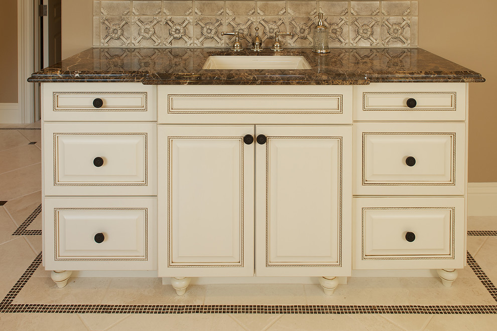 Mediterranean bathroom in San Francisco with beige cabinets and beige walls.