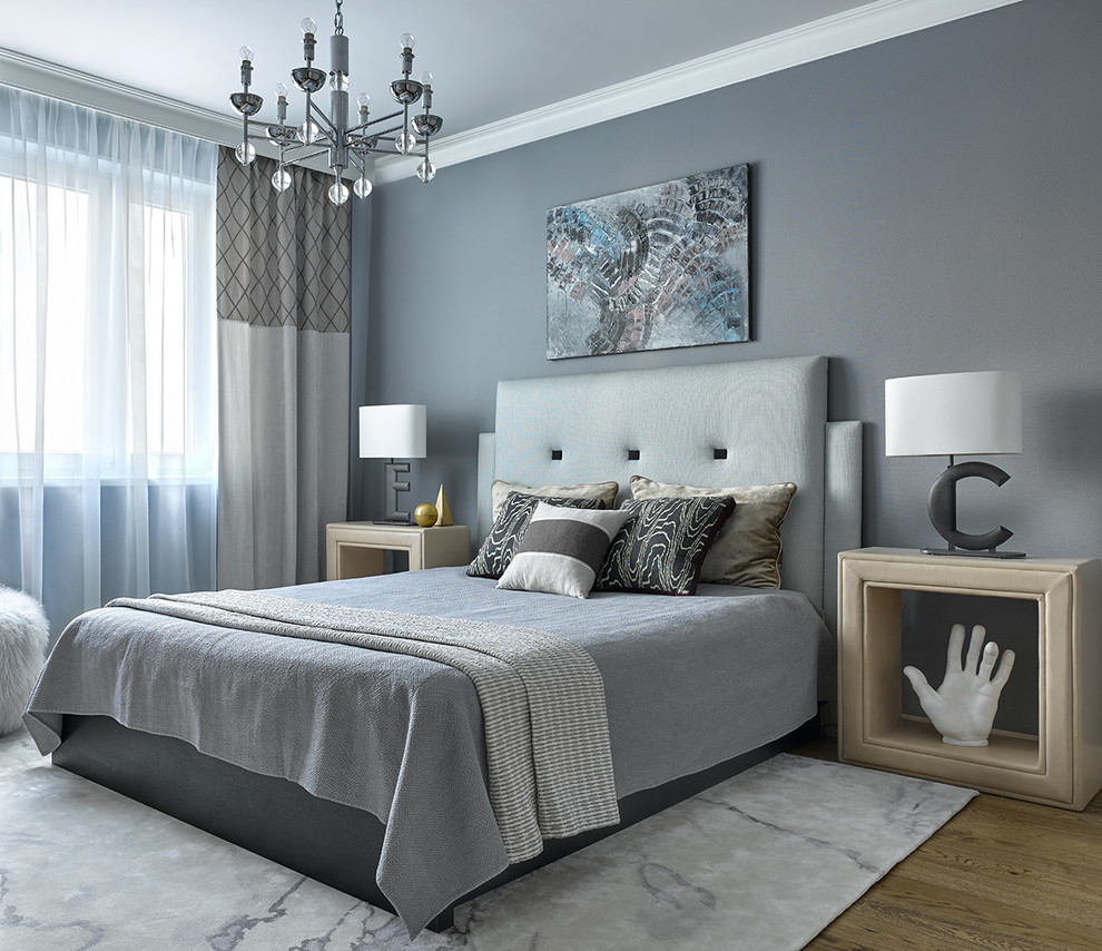 Photo of a transitional master bedroom in Moscow with grey walls, medium hardwood floors and brown floor.