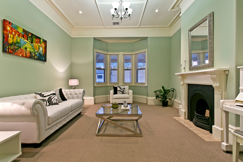 This is an example of a large beach style enclosed living room in Adelaide with green walls and carpet.