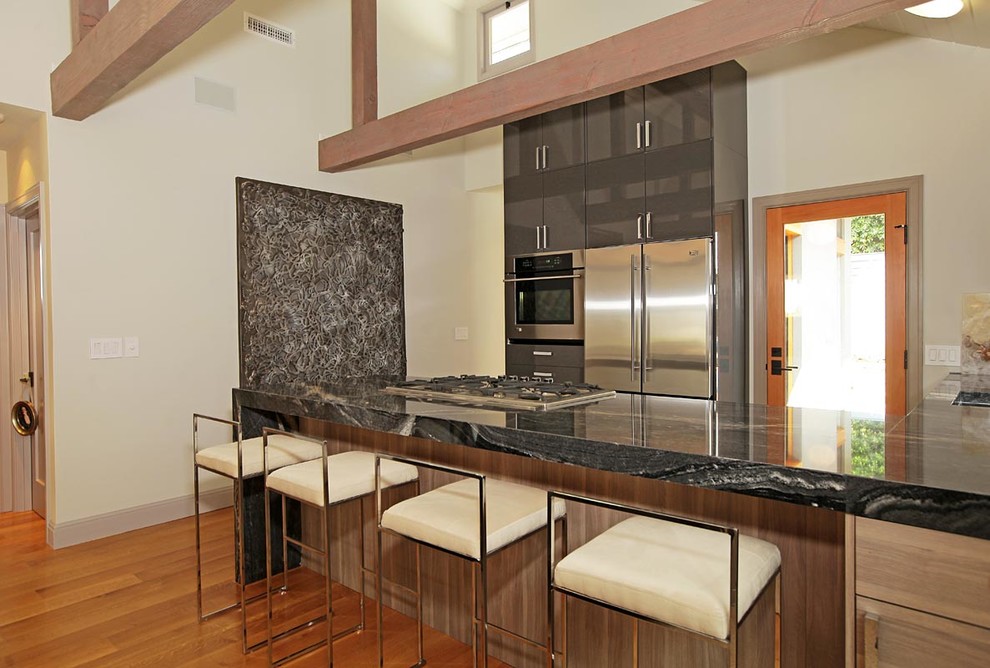 Photo of a contemporary l-shaped kitchen in Los Angeles with flat-panel cabinets and grey cabinets.