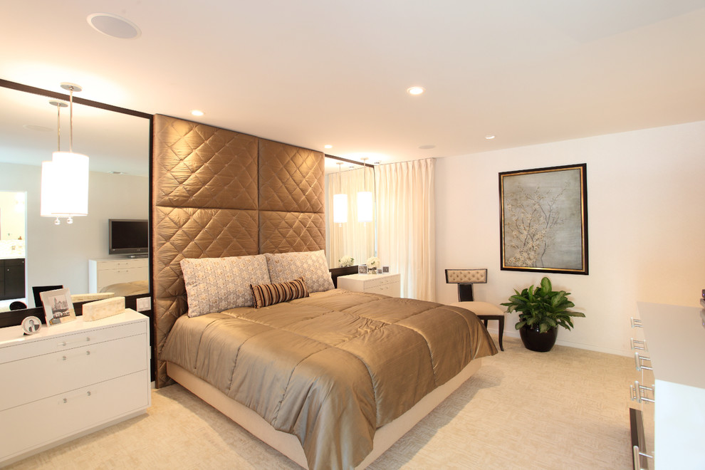 This is an example of a mid-sized modern loft-style bedroom in Los Angeles with carpet, white walls and no fireplace.