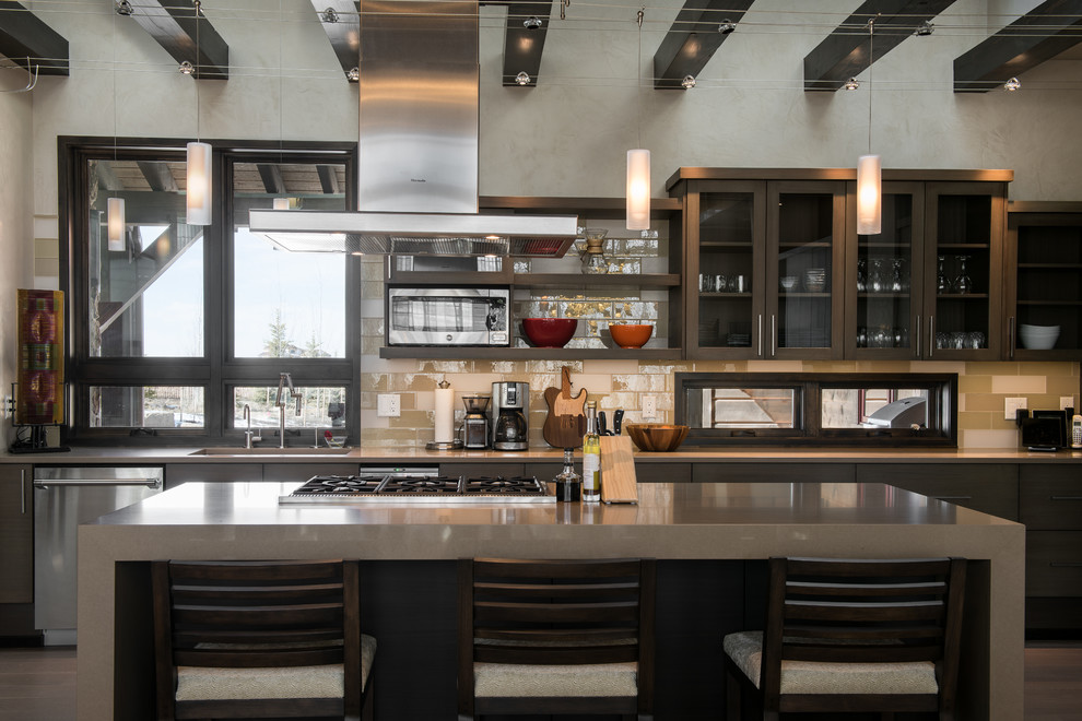 Inspiration for a mid-sized transitional l-shaped light wood floor and beige floor eat-in kitchen remodel with an undermount sink, quartz countertops, beige backsplash, glass tile backsplash, stainless steel appliances, an island, flat-panel cabinets and dark wood cabinets