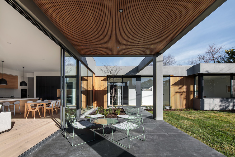Design ideas for a mid-sized contemporary backyard patio in Canberra - Queanbeyan.