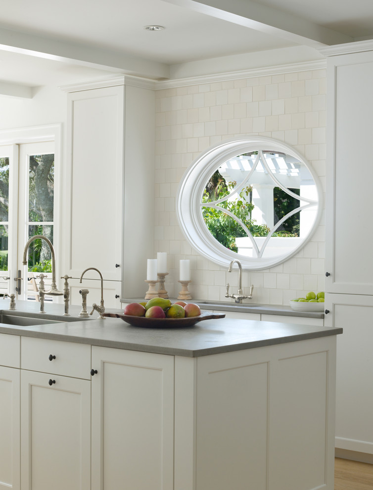 Inspiration for a tropical kitchen in Miami with recessed-panel cabinets and an undermount sink.