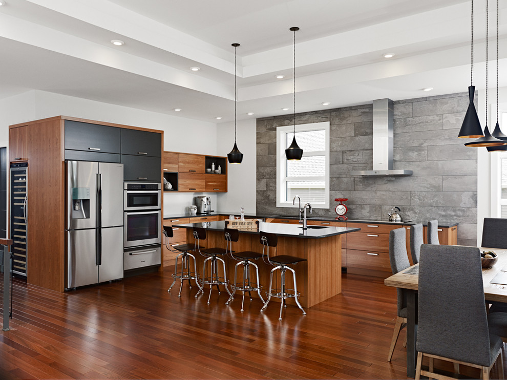 Photo of a mid-sized contemporary l-shaped eat-in kitchen in Other with a double-bowl sink, flat-panel cabinets, medium wood cabinets, quartz benchtops, grey splashback, ceramic splashback, stainless steel appliances, medium hardwood floors and with island.