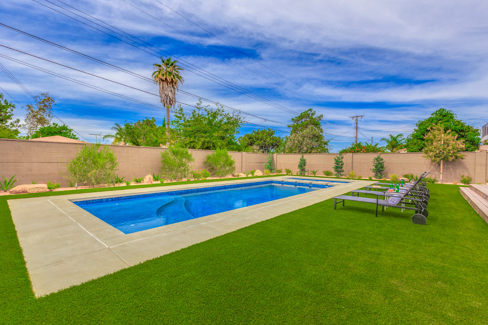 Large transitional backyard concrete and rectangular lap hot tub photo in Orange County