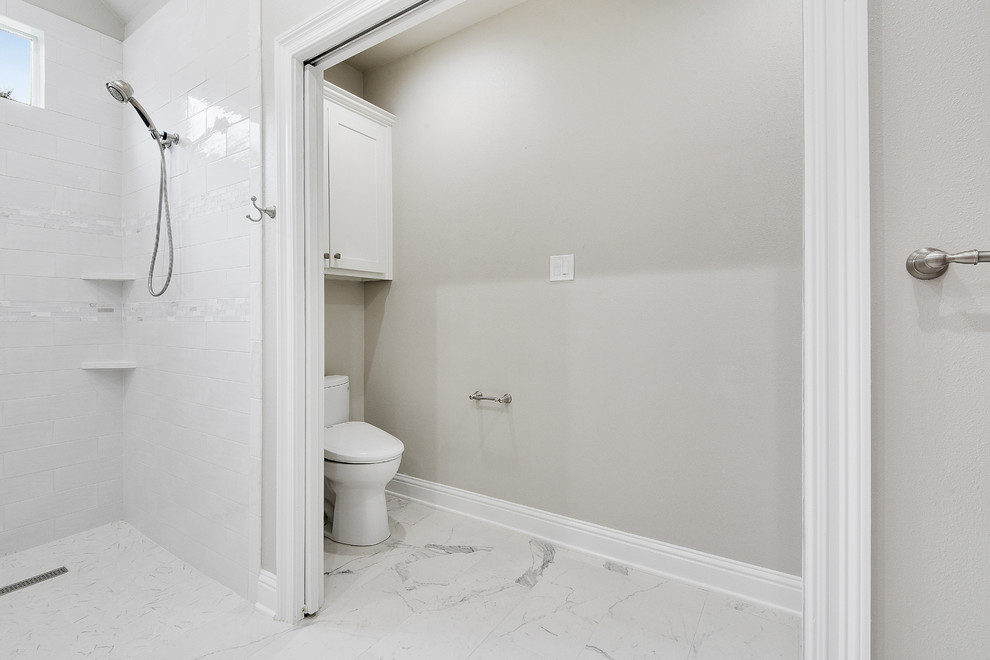 Inspiration for a large traditional master bathroom in New Orleans with shaker cabinets, white cabinets, an alcove shower, a two-piece toilet, white tile, subway tile, grey walls, porcelain floors, an undermount sink, quartzite benchtops, multi-coloured floor, an open shower and white benchtops.