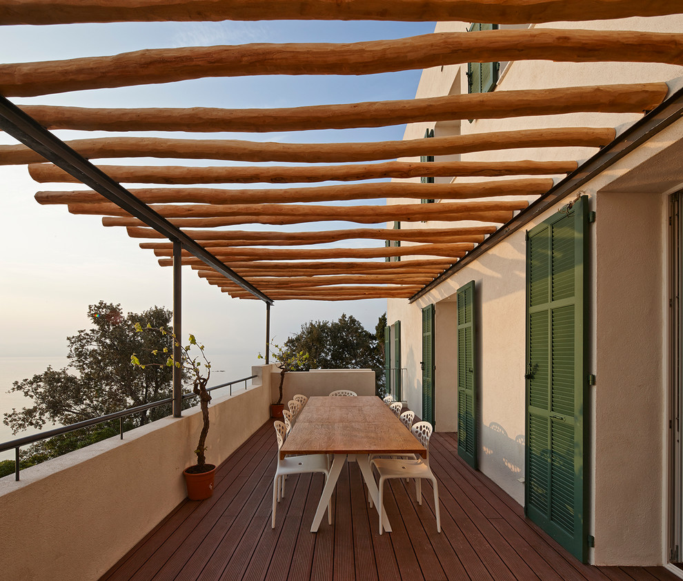 Design ideas for a mid-sized mediterranean balcony in Stuttgart with a pergola.