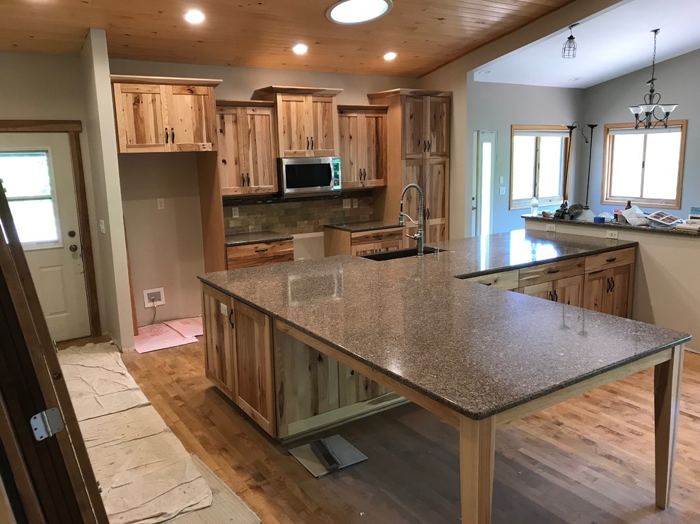 Inspiration for a mid-sized rustic galley eat-in kitchen remodel with an island
