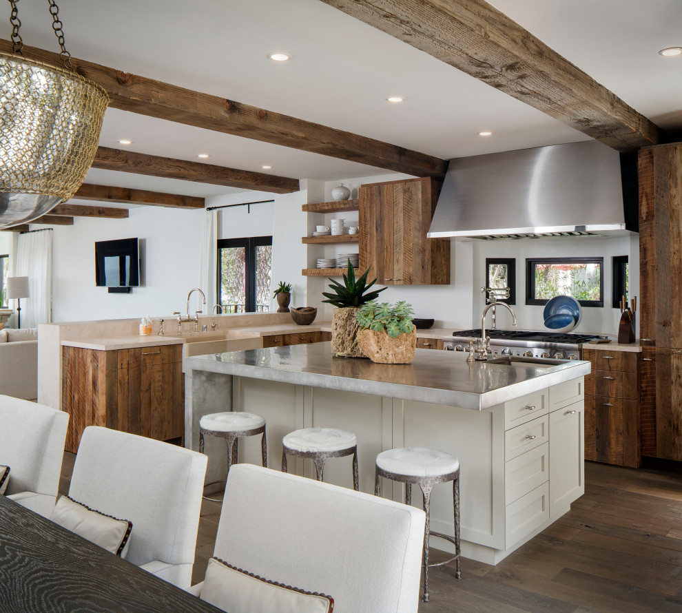This is an example of a transitional u-shaped eat-in kitchen in Orange County with an undermount sink, flat-panel cabinets, medium wood cabinets, stainless steel benchtops, panelled appliances, medium hardwood floors, with island, brown floor and grey benchtop.