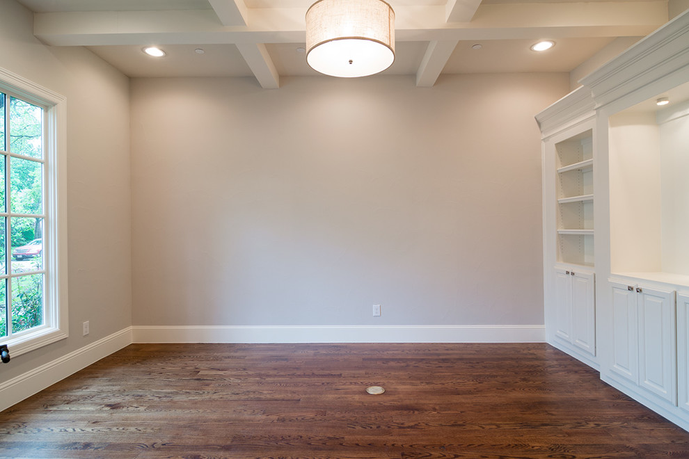 Photo of a mid-sized traditional study room in Dallas with beige walls, medium hardwood floors and a freestanding desk.