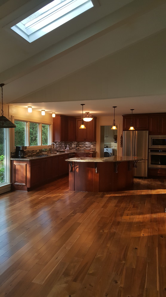 Design ideas for a mid-sized transitional l-shaped eat-in kitchen in Atlanta with a single-bowl sink, recessed-panel cabinets, medium wood cabinets, quartz benchtops, metallic splashback, mosaic tile splashback, stainless steel appliances, medium hardwood floors and with island.
