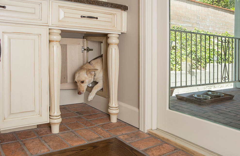 Inspiration for a mid-sized timeless l-shaped dark wood floor eat-in kitchen remodel in Los Angeles with an undermount sink, raised-panel cabinets, white cabinets, solid surface countertops, white backsplash, ceramic backsplash, stainless steel appliances and an island