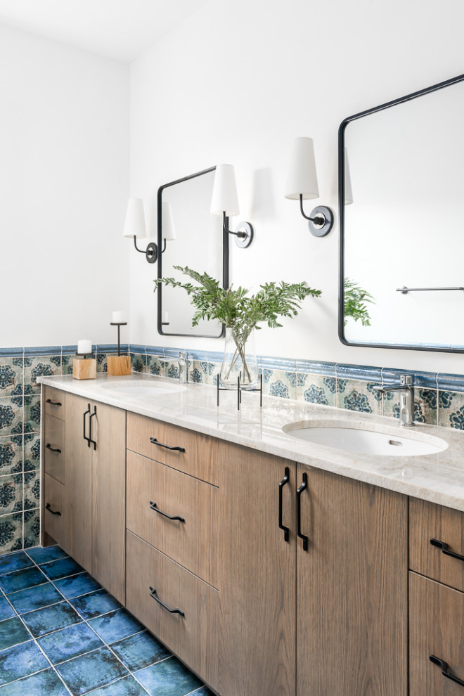 Photo of a mid-sized mediterranean master bathroom in Atlanta with flat-panel cabinets, medium wood cabinets, ceramic tile, white walls, quartzite benchtops, blue floor, beige benchtops, a double vanity, a built-in vanity, multi-coloured tile and an undermount sink.