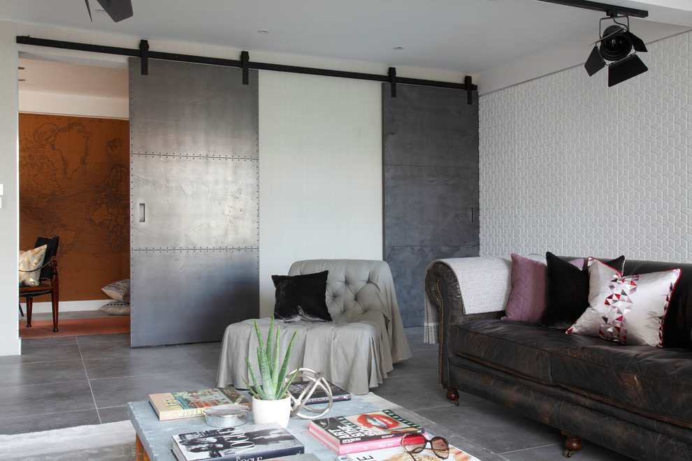 This is an example of a mid-sized industrial living room in London with concrete floors.