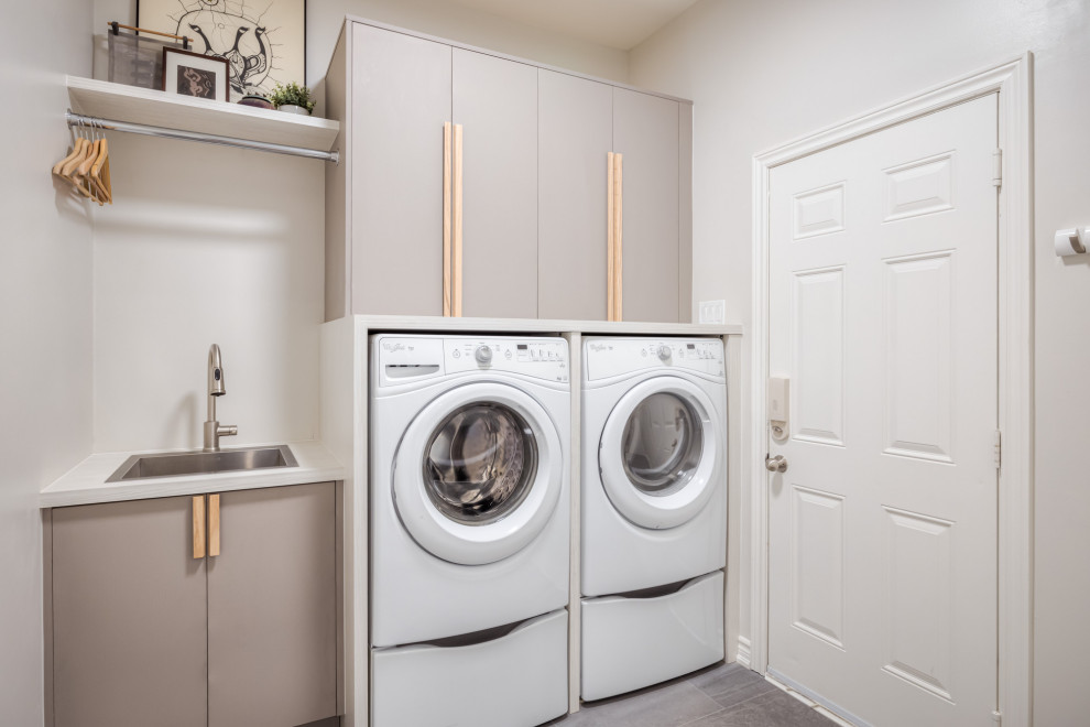 Photo of a small scandinavian single-wall separated utility room in Toronto with a single-bowl sink, flat-panel cabinets, beige cabinets, laminate countertops, white walls, ceramic flooring, a side by side washer and dryer, grey floors and white worktops.