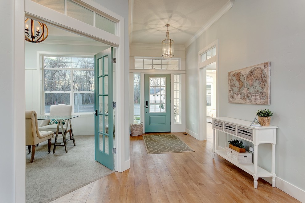 Inspiration for a large transitional foyer in Boise with blue walls, light hardwood floors, a single front door and a blue front door.