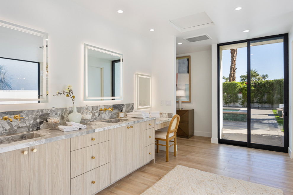 Bathroom - large transitional master porcelain tile, beige floor and double-sink bathroom idea with flat-panel cabinets, medium tone wood cabinets, white walls, an integrated sink, marble countertops, gray countertops and a freestanding vanity