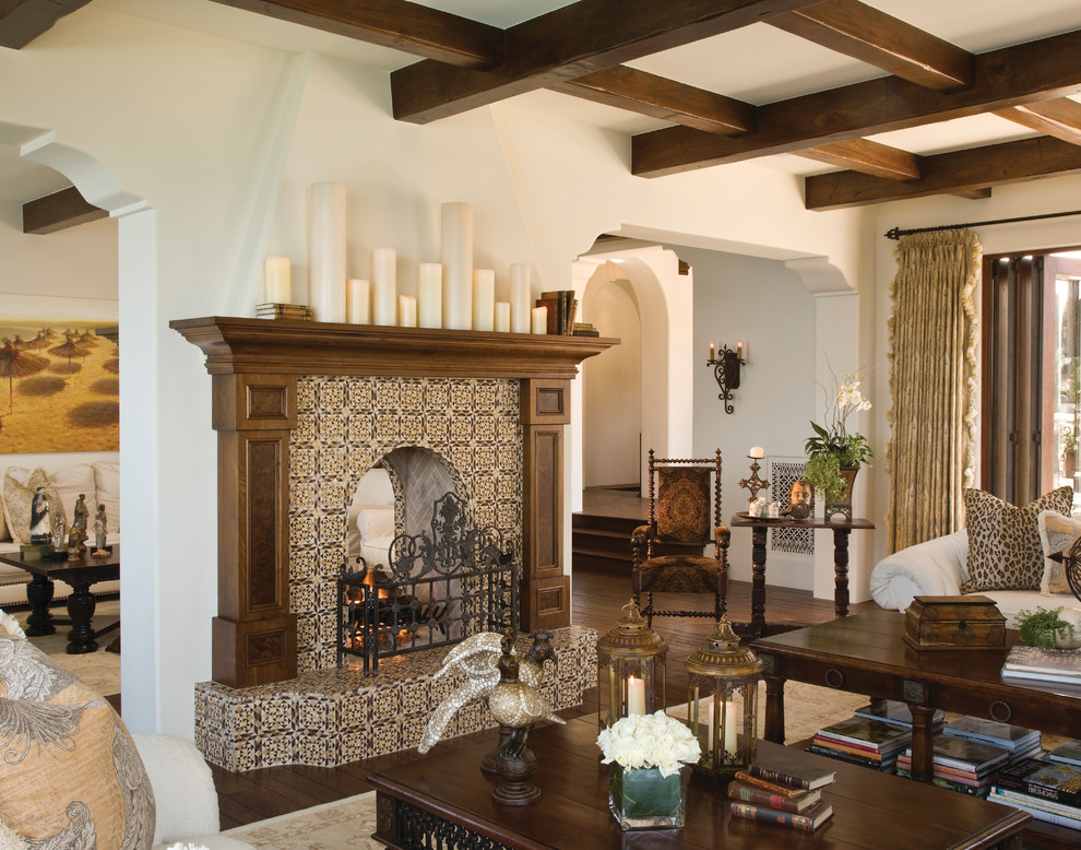 This is an example of a large mediterranean formal open concept living room in San Diego with white walls, dark hardwood floors, a two-sided fireplace, a tile fireplace surround, brown floor and no tv.