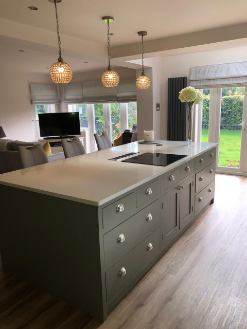 Sleek, light grey handmade kitchen with large island and white worktops modern-kitchen