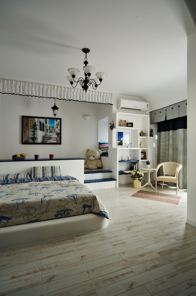 This is an example of a mediterranean kids' bedroom in Hong Kong with white walls and light hardwood floors.
