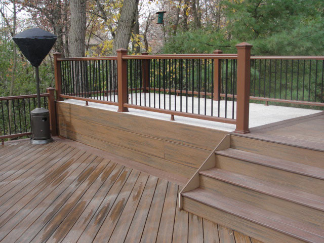 This is an example of a large transitional backyard deck in Other with no cover.