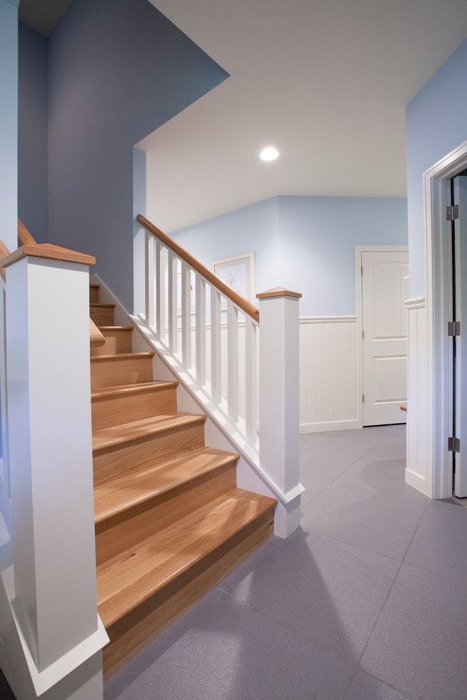 This is an example of a beach style hallway in Grand Rapids with blue walls, light hardwood floors and blue floor.