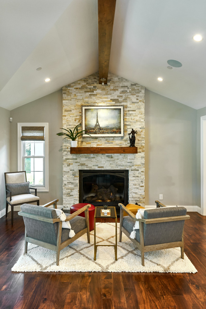 Inspiration for a medium sized traditional grey and white open plan living room in San Francisco with beige walls, medium hardwood flooring, a wall mounted tv, brown floors, a ribbon fireplace, a stacked stone fireplace surround, a vaulted ceiling and a chimney breast.
