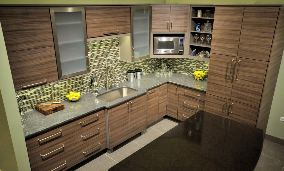 Photo of a mid-sized transitional l-shaped eat-in kitchen in Chicago with an undermount sink, flat-panel cabinets, medium wood cabinets, granite benchtops, multi-coloured splashback, matchstick tile splashback, stainless steel appliances, ceramic floors, with island and grey floor.