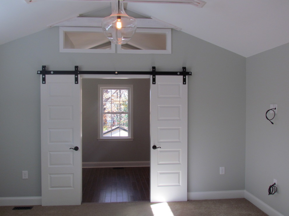 Photo of a large traditional master bedroom in Raleigh with grey walls, carpet, no fireplace and beige floor.