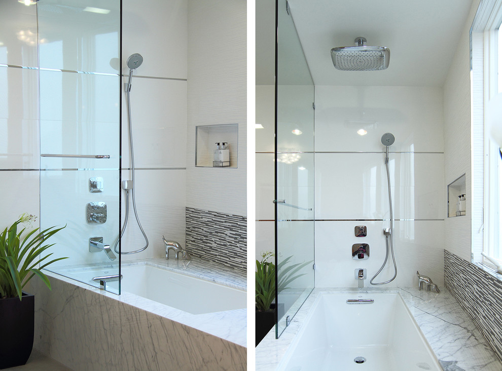 Photo of a modern bathroom in San Francisco with a vessel sink, a drop-in tub, an open shower, a two-piece toilet, flat-panel cabinets, black cabinets, engineered quartz benchtops, white tile and ceramic tile.